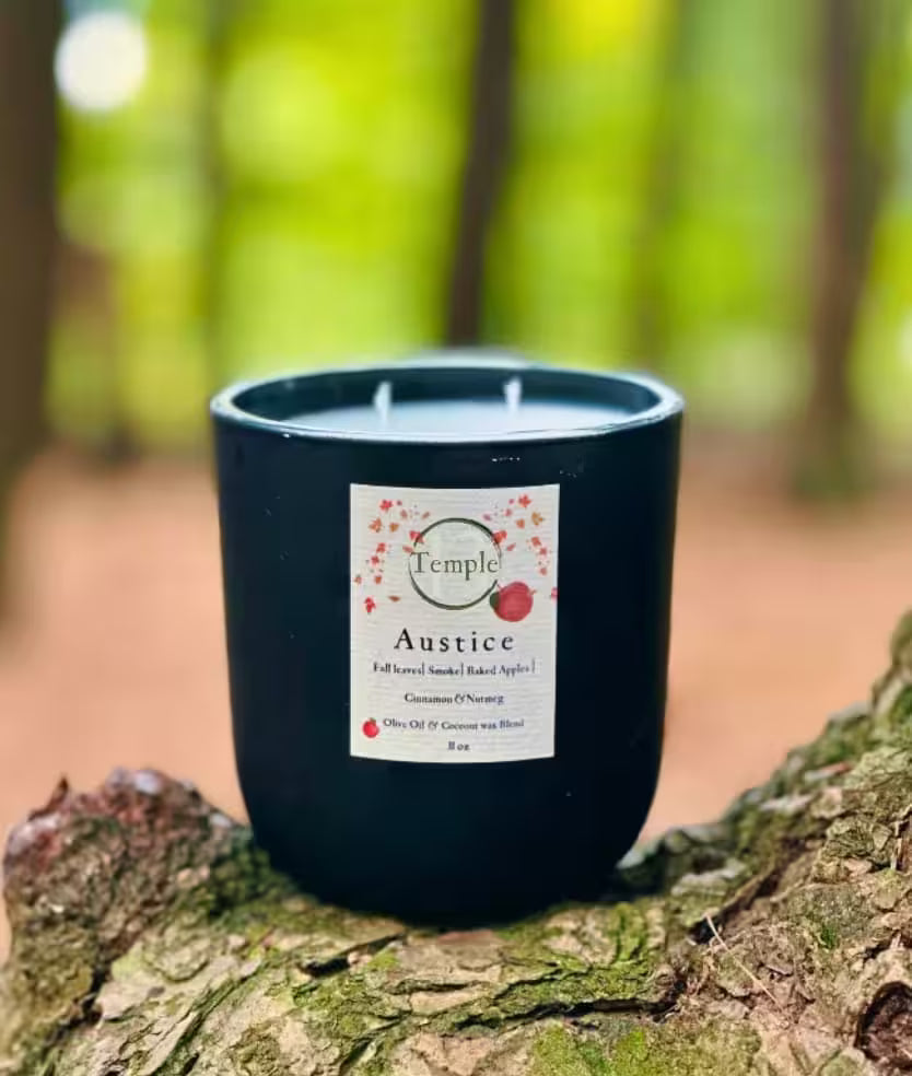 Black candle with a label on a tree stump  in a forest setting
