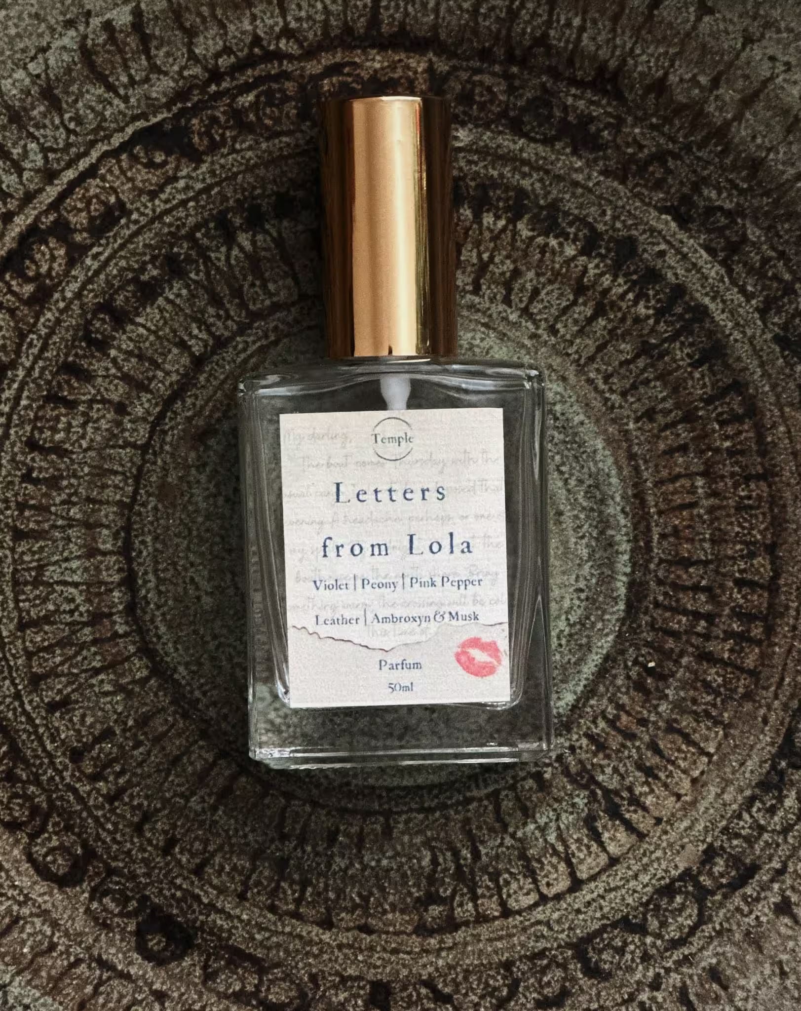 Perfume bottle labeled 'Letters from Lola' on a textured surface