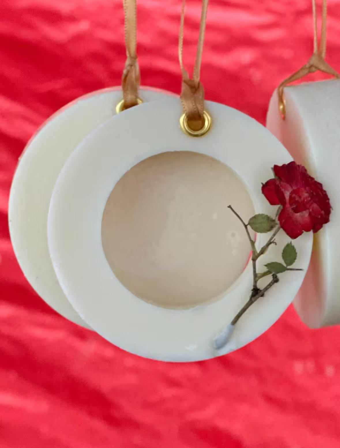 Decorative circular ornament with a red rose on a red background