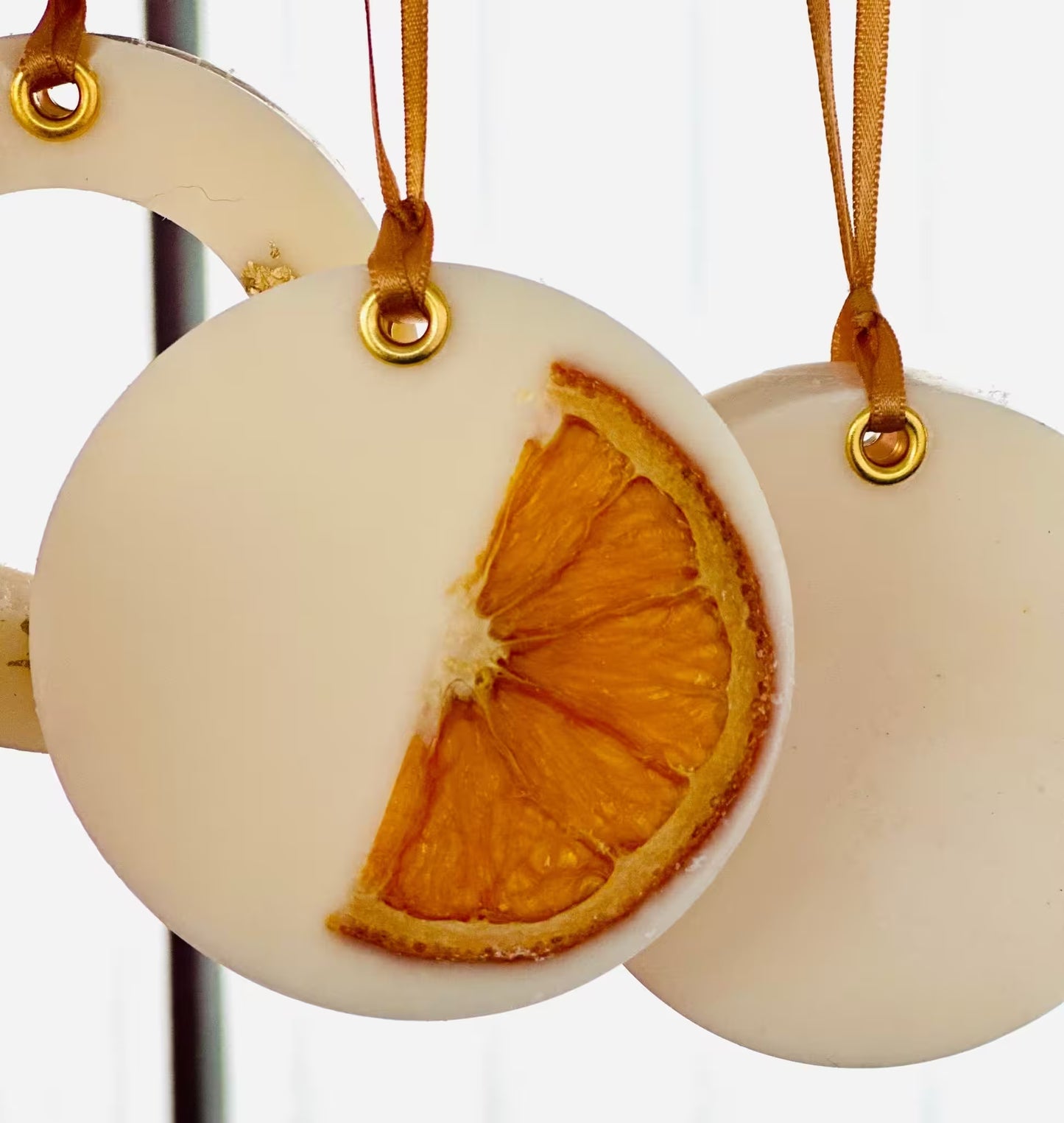 Decorative ornament with a dried orange slice on a white background