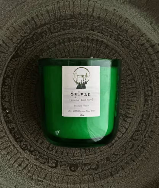 Green candle with a label on a textured surface